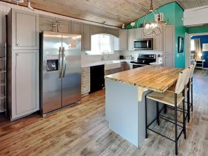 a kitchen with a wooden counter top and a refrigerator at Sand Piper in Rockport