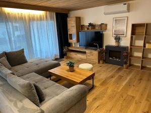 a living room with a couch and a coffee table at Apartment in Saalfelden near Ski Slopes in Saalfelden am Steinernen Meer