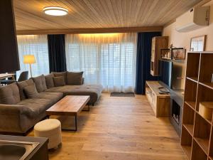 a living room with a couch and a table at Apartment in Saalfelden near Ski Slopes in Saalfelden am Steinernen Meer