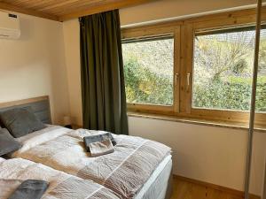 a bedroom with a bed and a large window at Apartment in Saalfelden near Ski Slopes in Saalfelden am Steinernen Meer