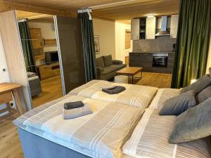 a large bed with two towels on it in a room at Apartment in Saalfelden near Ski Slopes in Saalfelden am Steinernen Meer