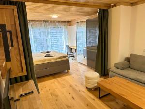 a living room with a bed and a couch at Apartment in Saalfelden near Ski Slopes in Saalfelden am Steinernen Meer