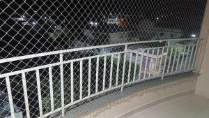 a white railing on a balcony with a window at Apartamento Bela vista Aperibé in Aperibé