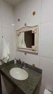 a bathroom with a sink and a mirror at Apartamento Bela vista Aperibé in Aperibé +18 photos
