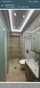 uma casa de banho com um chuveiro, um WC e um lavatório. em Sami View em Sami mais 37 fotografias