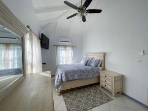 a bedroom with a bed and a ceiling fan at Grace's Place in Sapphire