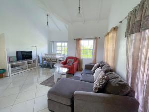 a living room with a couch and a table at Grace's Place in Sapphire