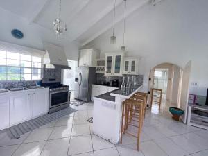 a large kitchen with white cabinets and appliances at Grace's Place in Sapphire