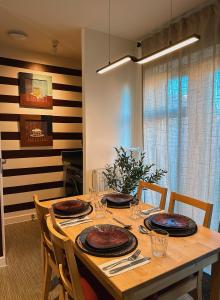a dining room table with plates on top of it at Villa Noria in Kingston Bagpuze