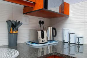 a kitchen counter with a coffee maker and a toaster at Enitre House! Long Stay! Relocating! Business! in Johannesburg
