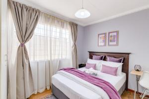 a bedroom with a large bed and a window at Enitre House! Long Stay! Relocating! Business! in Johannesburg +14 photos