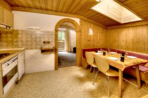 a kitchen and dining room with a table and chairs at Haus Brandner in Viehhofen