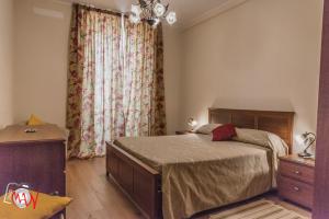 a bedroom with a bed and a dresser and a window at Hotel Moderno in Lecco