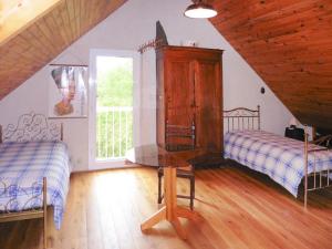a attic bedroom with two beds and a table at Holiday Home in Piriac near Sandy Beach in Piriac-sur-Mer