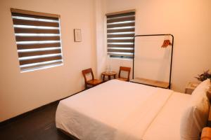 Ein Bett oder Betten in einem Zimmer der Unterkunft Charm House Hue
