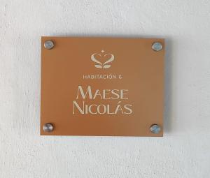 a sign on a wall that reads massage nucales at La Casa Veintidós in Guanajuato