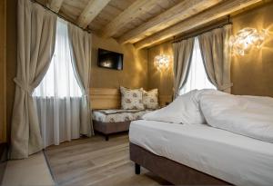 Postel nebo postele na pokoji v ubytování Hotel Orso Grigio