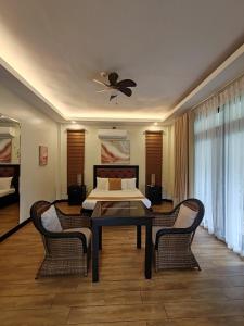 a living room with a table and two chairs at The Zen Villas Resort in Lipa