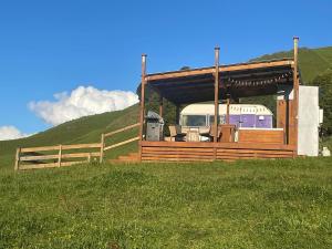 a rv parked in a field next to a fence at Vintage Caravan Retreat Outdoor bath Ruapehu Unique Stays in Taumarunui