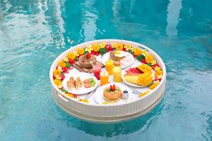 a table with food and drinks in a pool at Villa Mia Seminyak - Boutique Villas in Seminyak