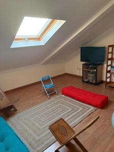 a living room with a skylight and a red couch at Villa Mont Horizon in Saint-Pierre +8 photos