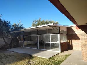 a building with large glass doors on it at Los Olivos Apart in San Rafael