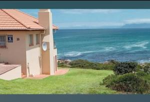 a house with a view of the ocean at ROMANZA APARTMeNT in De Kelders