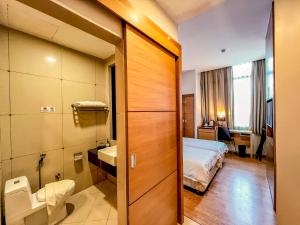 a hotel room with a bed and a bathroom at Courtyard Hotel 1Borneo in Kota Kinabalu