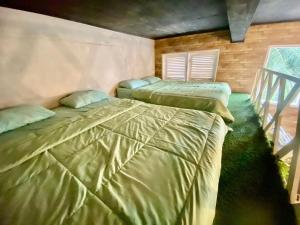 a bedroom with two beds in a room at Villa Kay Village in Cipaok +20 photos