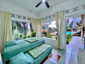 a bedroom with a bed and a large window at Villa Kay Village in Cipaok