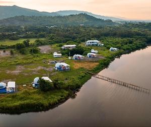 an aerial view of a group of tents next to a river at AmanDagat Beach Resort in Sindol