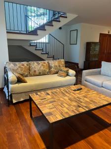 a living room with a couch and a coffee table at Al Puente y Palo - Casa del Arbol in San Lorenzo