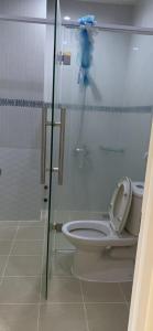 a bathroom with a toilet and a glass shower stall at Hữu Đặng in Chau Doc