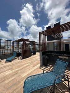 a deck with two blue benches on top of a building at Bessa Flat Conforto à 180m do Mar - Storey Luxor in João Pessoa