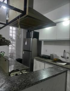 a kitchen with a counter top and a refrigerator at Habitaciones Casa Compartida in Montevideo