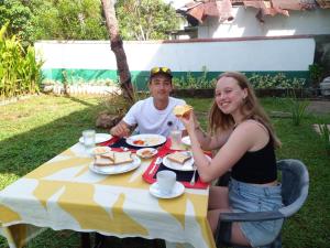 a man and a woman sitting at a table eating food at Paradise Galle in Galle