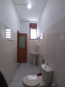 a bathroom with a toilet and a sink at Paradise Galle in Galle
