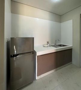 a kitchen with a stainless steel refrigerator and a sink at Nawasena Suites in Sanur +6 photos