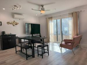 a living room with a table and a television at Chic, Cozy & Comfort Modern Room in Austin