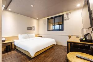 a hotel room with a bed and a window at DUBLIN Hotel in Busan