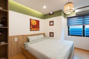 a bedroom with a bed and a window at Home of Serenity - 3 BR & 3 baths - 1' to Hoan Kiem Lake & Old Quarter in Hanoi