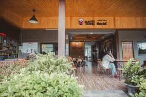 a man sitting at a table in a building at Warmwell Hostel in Ban Chuk Kum