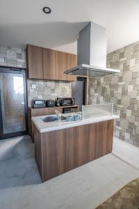 a kitchen with a sink and a stove at Free Parking and Sauna INDIGO GEO HOUSE DS2DS3 in Tajiri
