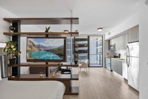 a kitchen and living room with a large screen tv at Luxury Studio,Downtown Miami, in Miami