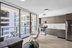 a living room with a couch and a kitchen at Luxury Studio,Downtown Miami, in Miami +19 photos