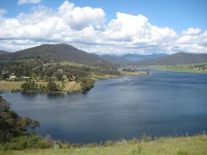 una gran masa de agua con montañas al fondo en Coves Cottage, en Piries