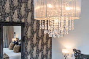 a chandelier hanging in front of a mirror at Orewa Beachcomber in Orewa