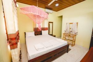 Postel nebo postele na pokoji v ubytování Suwani Pinnawala Homestay