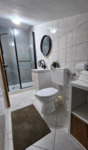 a bathroom with a toilet and a sink and a shower at Apartments Vahovec Vodice in Vodice +45 photos