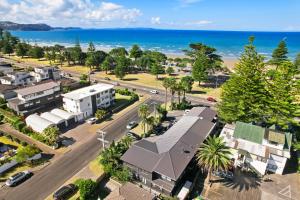 an aerial view of a city with the ocean at Orewa Beachcomber in Orewa